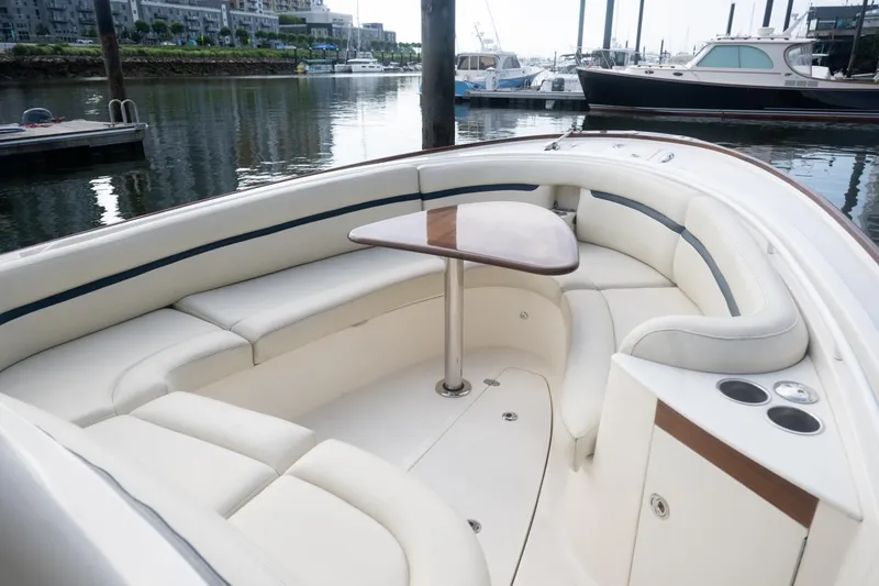 Slide: The Image of 2019 Hunt Yachts 32 Center Console with elegant seating and table, docked in a marina. - 29