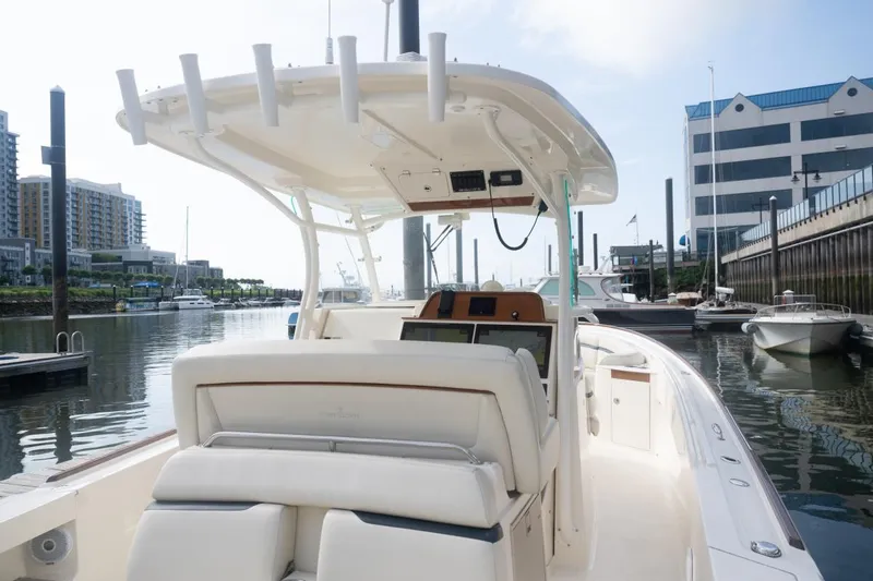 Slide: The Image of 2019 Hunt Yachts 32 Center Console docked in a marina, showcasing sleek design and modern features. - 31