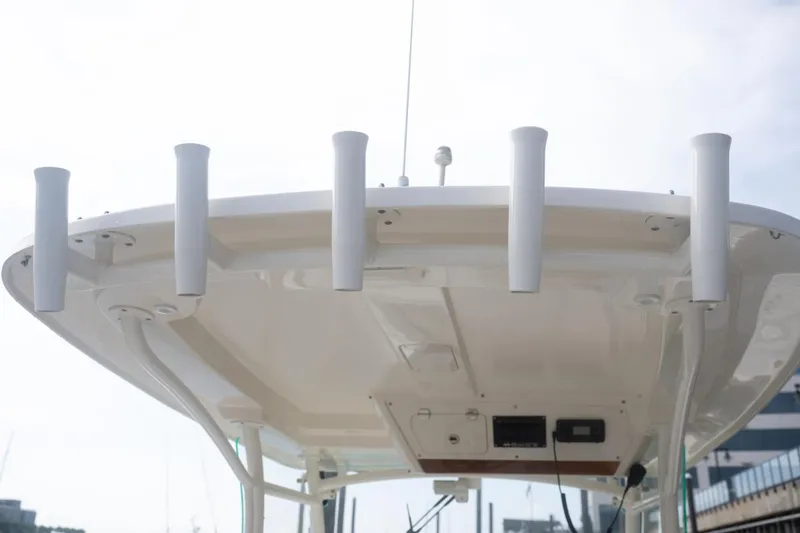 Slide: The Image of 2019 Hunt Yachts 32 Center Console boat roof with rod holders and electronics. - 32