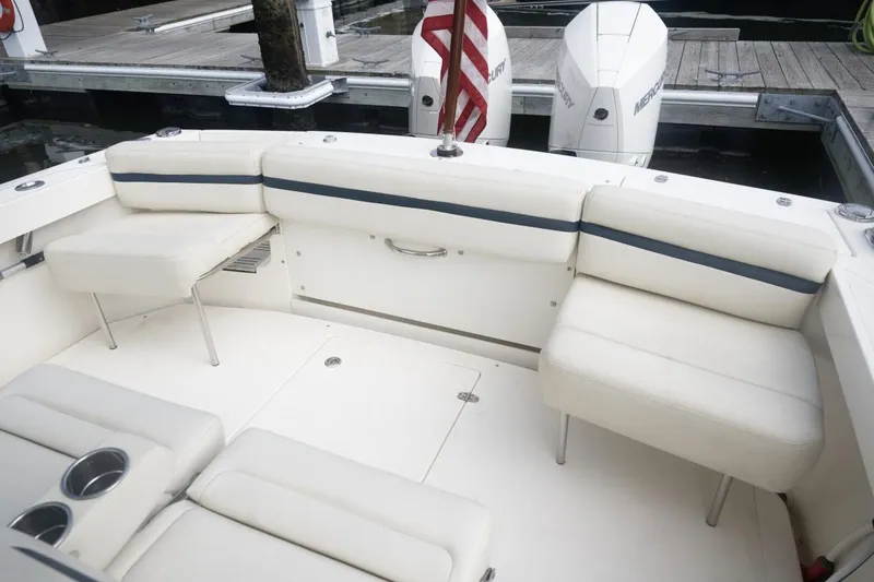 Slide: The Image of 2019 Hunt Yachts 32 Center Console, white seating area, docked with twin Mercury engines. - 33