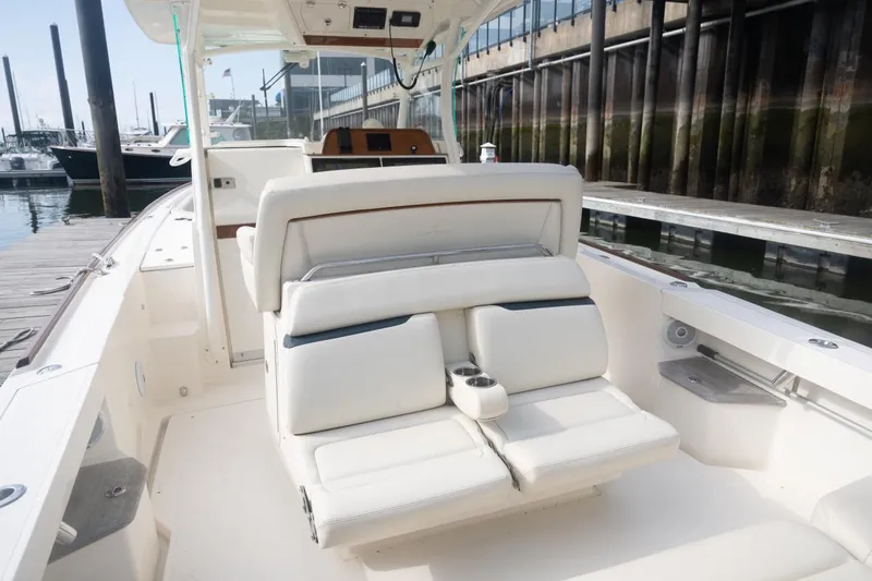 Slide: The Image of 2019 Hunt Yachts 32 Center Console with white seating, docked at a marina. - 35