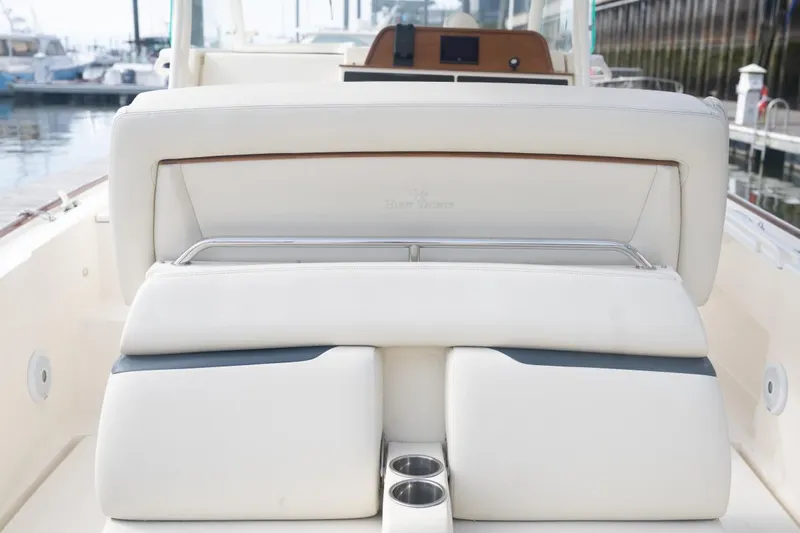 Slide: The Image of 2019 Hunt Yachts 32 Center Console, featuring luxurious white seating and cup holders. - 37