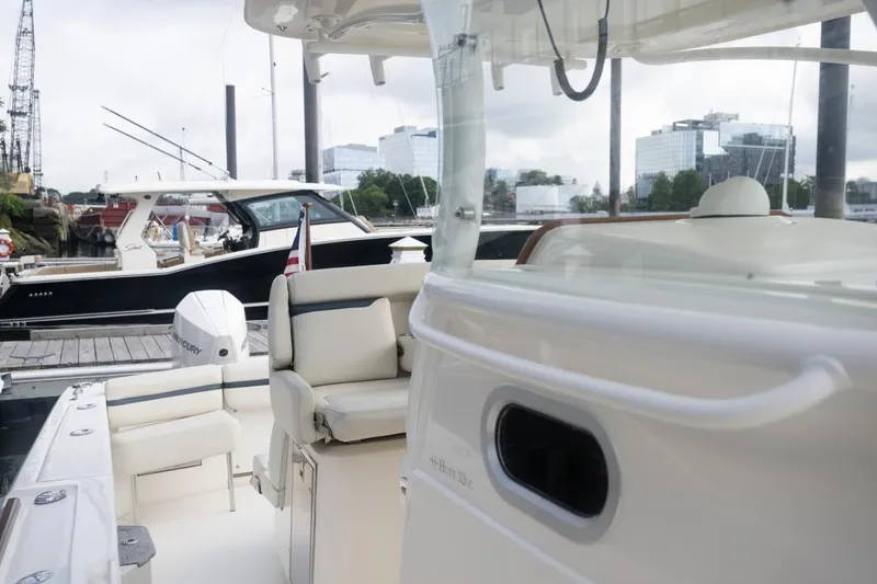 Slide: The Image of 2019 Hunt Yachts 32 Center Console at marina, featuring sleek design and comfortable seating. - 38