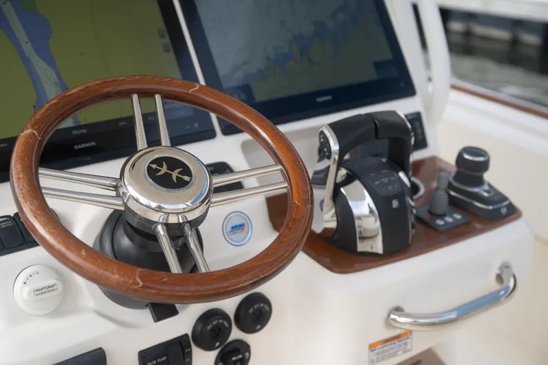 Slide: The Image of Steering wheel and controls of 2019 Hunt Yachts 32 Center Console boat. - 39