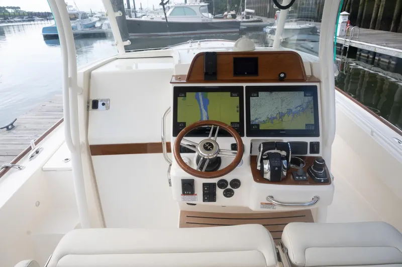 Slide: The Image of 2019 Hunt Yachts 32 Center Console helm with dual navigation screens and steering wheel. - 41