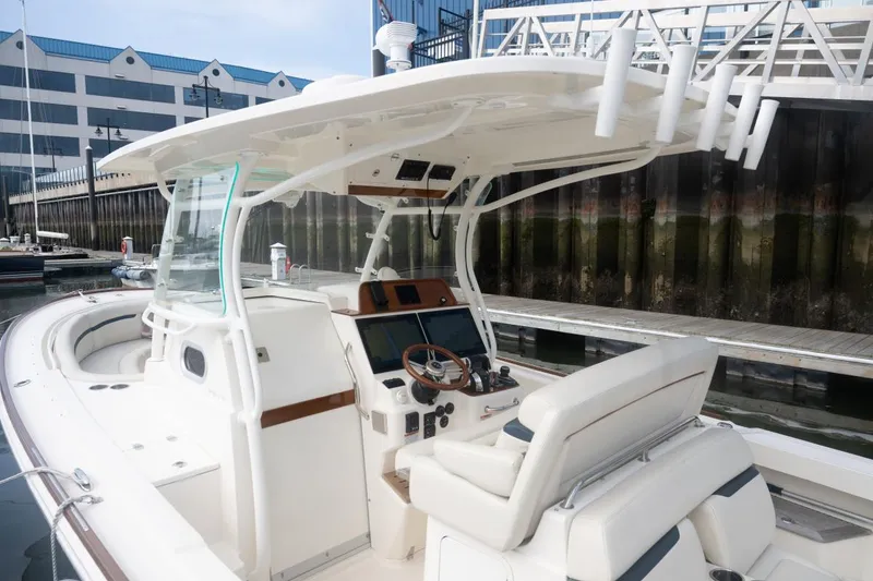 Slide: The Image of 2019 Hunt Yachts 32 Center Console at dock, featuring sleek design and modern controls. - 42