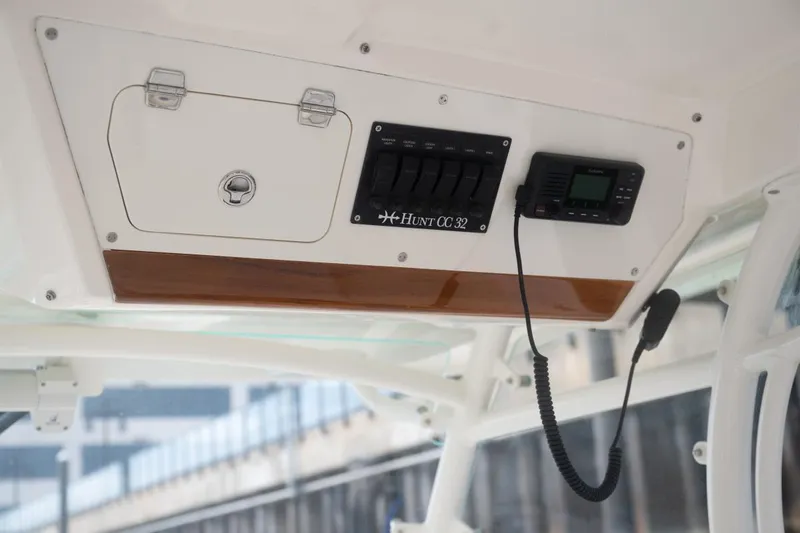 Slide: The Image of 2019 Hunt Yachts 32 Center Console dashboard with controls and radio equipment. - 43