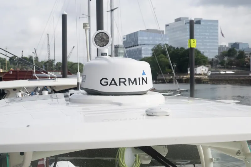 Slide: The Image of 2019 Hunt Yachts 32 Center Console with Garmin radar, docked near modern buildings. - 44
