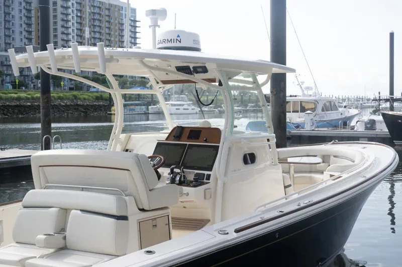 Slide: The Image of 2019 Hunt Yachts 32 Center Console docked, featuring sleek design and modern navigation equipment. - 46