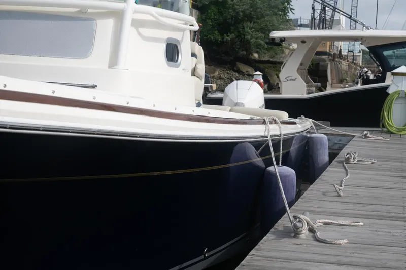 Slide: The Image of 2019 Hunt Yachts 32 Center Console docked with fenders and ropes. - 49