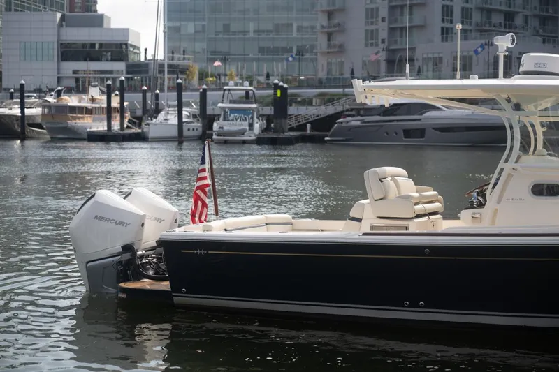 Slide: The Image of 2019 Hunt Yachts 32 Center Console docked in marina, featuring Mercury outboard engines. - 9