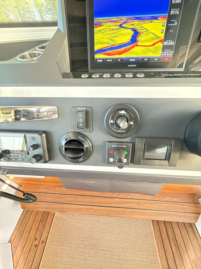 Slide: The Image of Control panel of 2019 Axopar 28 CABIN with navigation display and controls. - 14