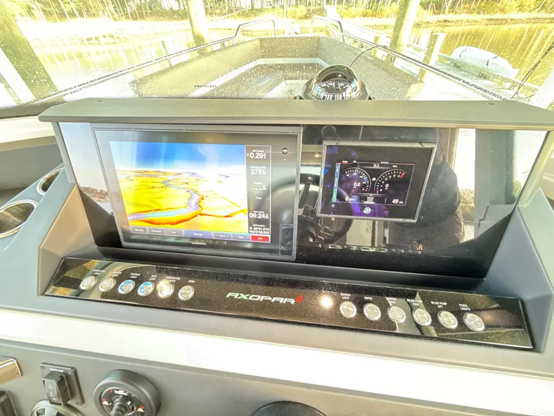 Slide: The Image of Axopar 28 CABIN 2019 dashboard with navigation and control displays. - 17