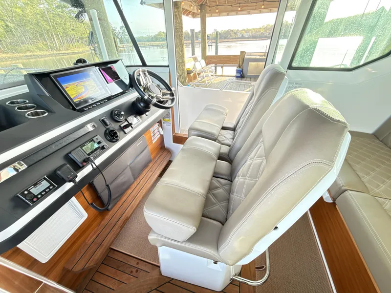 Slide: The Image of Interior of 2019 Axopar 28 CABIN boat with modern dashboard and comfortable seating. - 28