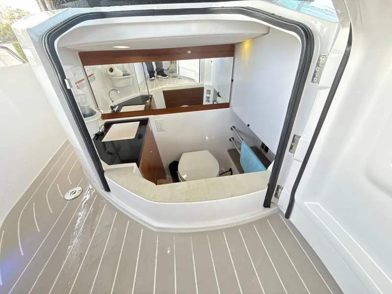 Slide: The Image of 2019 Axopar 28 CABIN interior view with modern amenities and sleek design. - 35