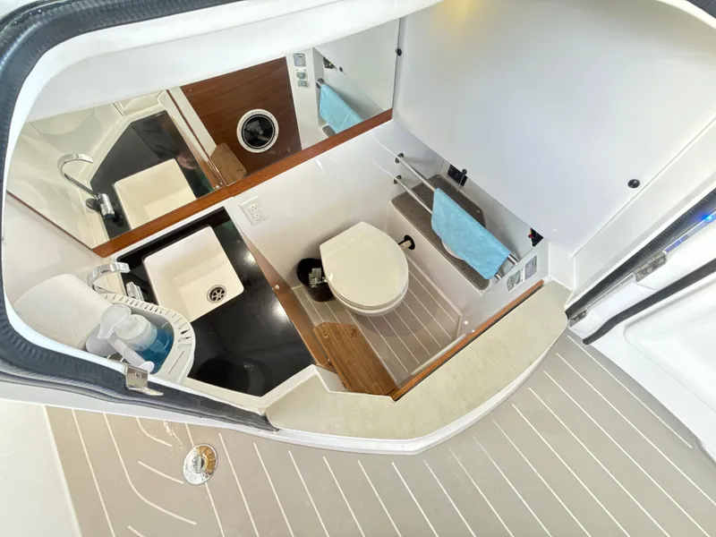 Slide: The Image of 2019 Axopar 28 CABIN bathroom with sink, toilet, and storage. - 36