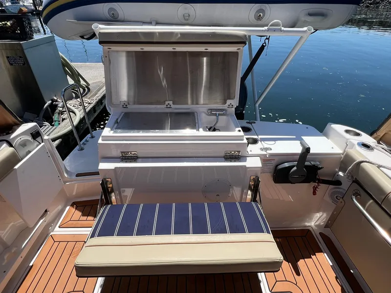 Slide: The Image of 2020 Ranger Tugs R-27 boat interior with open storage compartment and seating. - 10