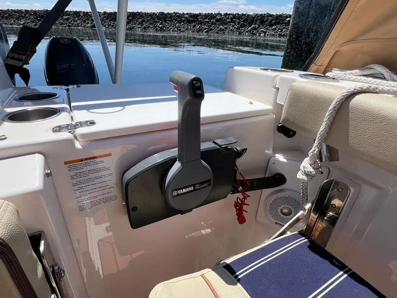 Slide: The Image of 2020 Ranger Tugs R-27 boat interior with Yamaha throttle control and seating. - 12