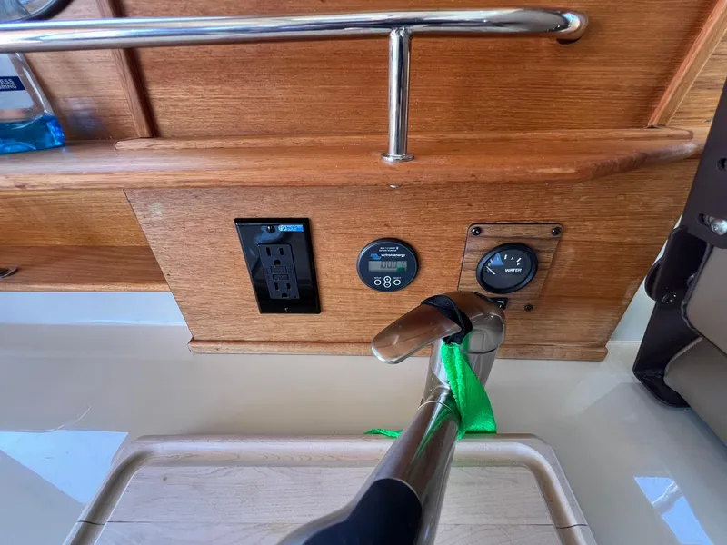 Slide: The Image of 2020 Ranger Tugs R-27 interior with faucet, power outlet, and control panel. - 16