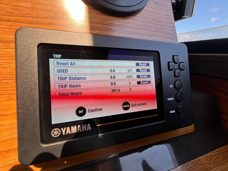 Slide: The Image of Yamaha display on 2020 Ranger Tugs R-27 showing trip and total hours data. - 27