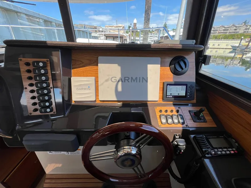 Slide: The Image of Helm of 2020 Ranger Tugs R-27 with Garmin navigation system and wooden steering wheel. - 28