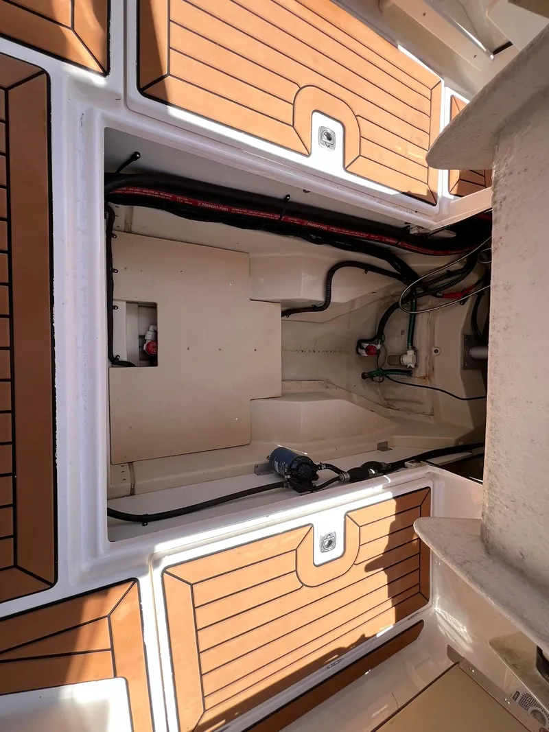 Slide: The Image of 2020 Ranger Tugs R-27 boat interior with wood accents and visible wiring. - 29