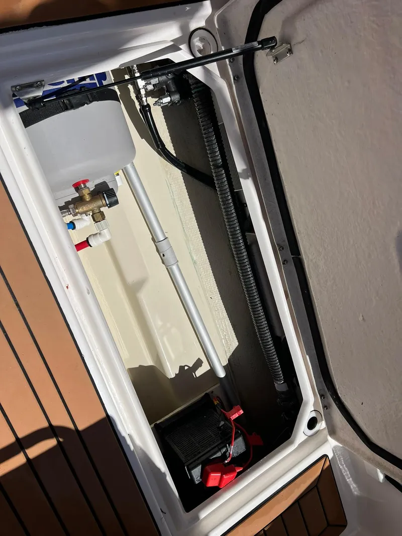 Slide: The Image of 2020 Ranger Tugs R-27 boat compartment with mechanical components and wiring. - 30