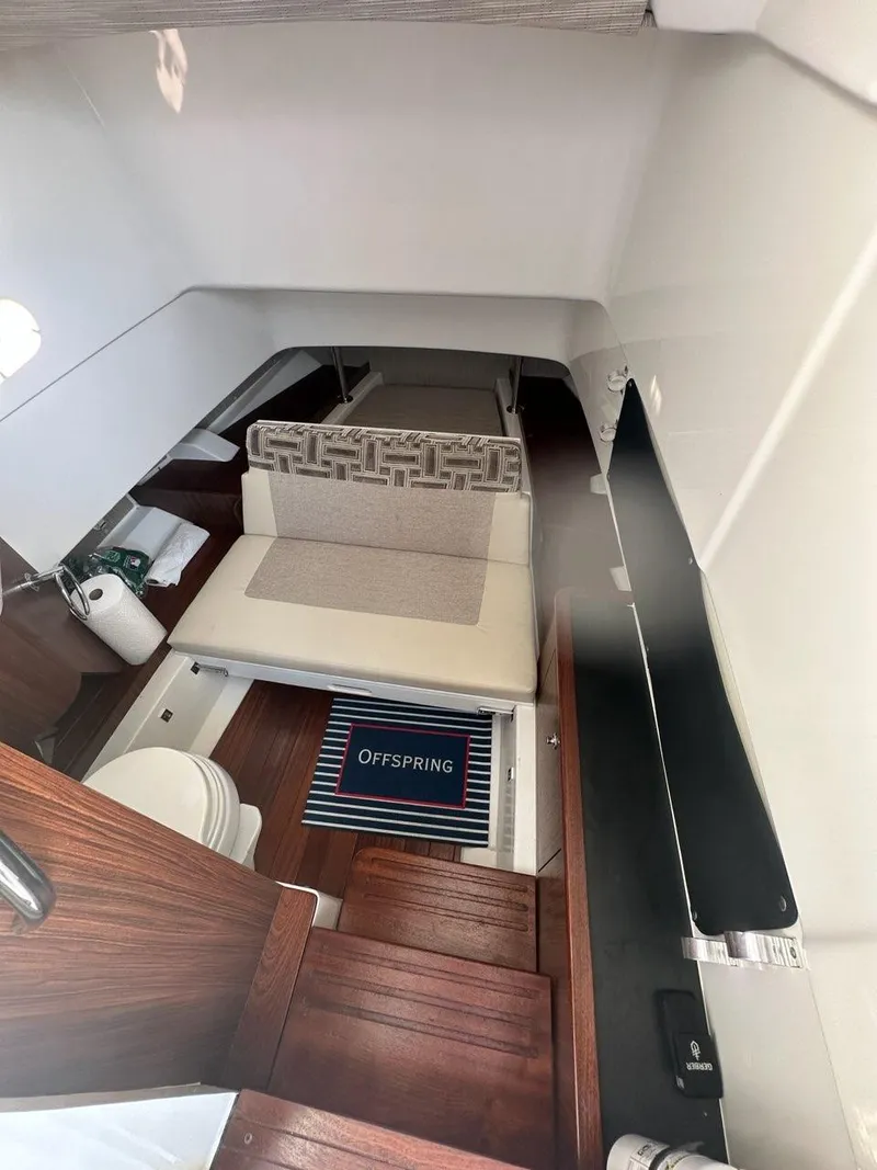 Slide: The Image of 2022 Pursuit S 328 Sport cabin interior with seating and wooden flooring. - 19