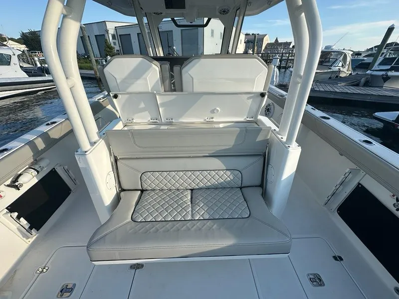 Slide: The Image of 2022 Pursuit S 328 Sport boat interior with cushioned seating and sleek design. - 26