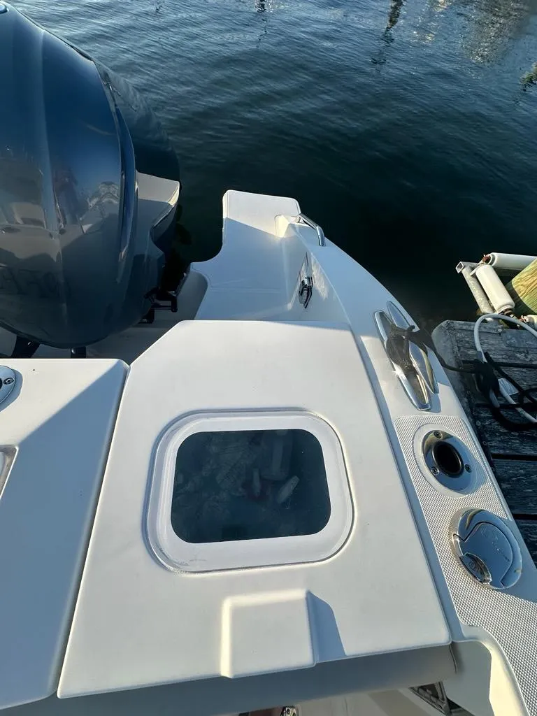 Slide: The Image of 2022 Pursuit S 328 Sport boat stern with engine and water view. - 28