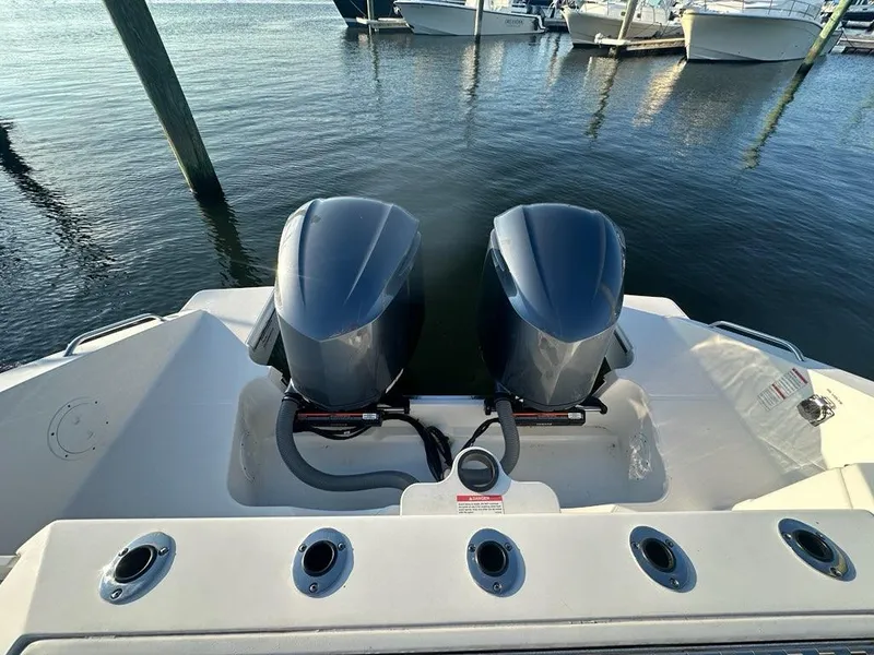 Slide: The Image of 2022 Pursuit S 328 Sport boat with dual engines docked at marina. - 29