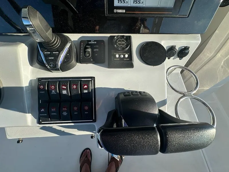 Slide: The Image of Control panel of 2022 Pursuit S 328 Sport boat with switches and throttle. - 5