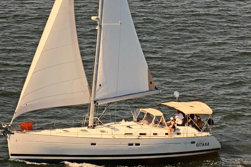 The Image of 2006 Beneteau Oceanis 523 sailboat cruising on open water with full sails. - 1