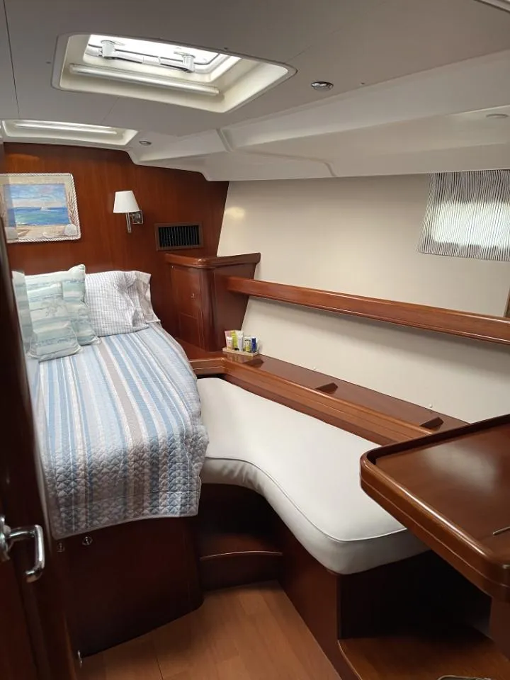 Slide: The Image of Luxurious cabin interior of 2006 Beneteau Oceanis 523 yacht with cozy bed and seating. - 12