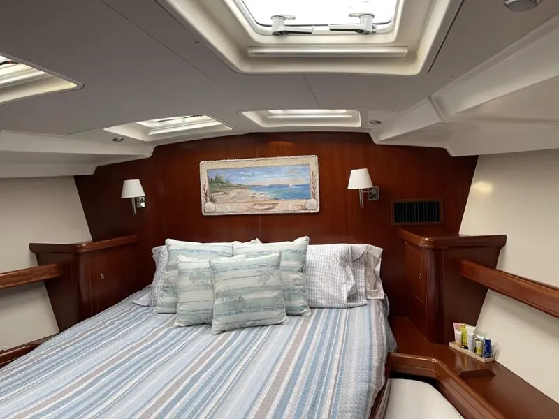Slide: The Image of Luxurious cabin interior of 2006 Beneteau Oceanis 523 yacht with cozy bedding and elegant wood finish. - 13
