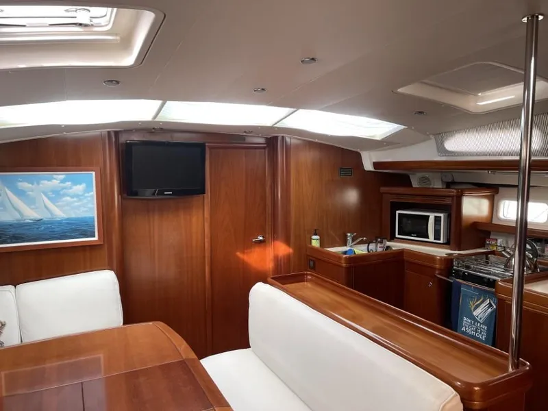 Slide: The Image of Interior of 2006 Beneteau Oceanis 523 yacht with wood finish and modern amenities. - 16