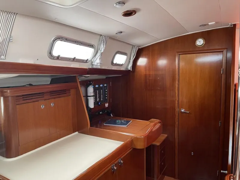 Slide: The Image of Interior of 2006 Beneteau Oceanis 523 yacht with wooden cabinetry and navigation station. - 17