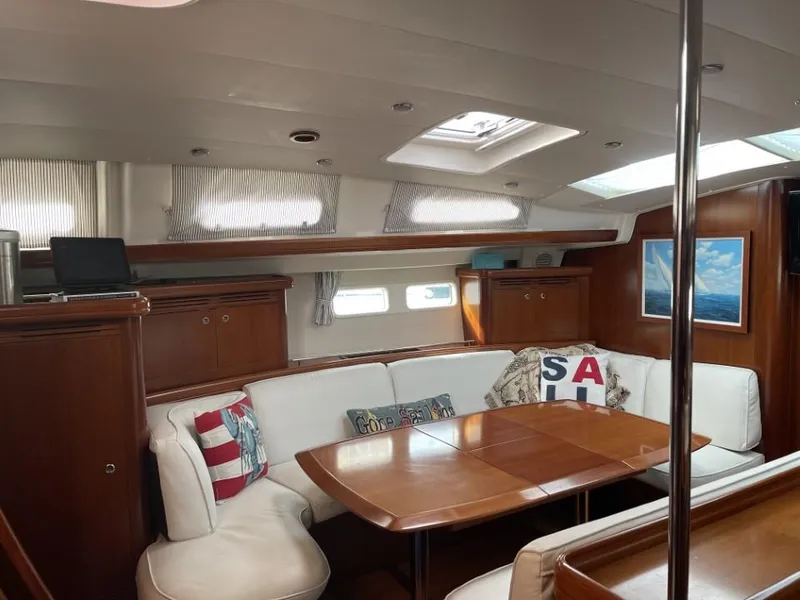 Slide: The Image of Interior of 2006 Beneteau Oceanis 523 yacht with elegant wood finish and cozy seating area. - 18