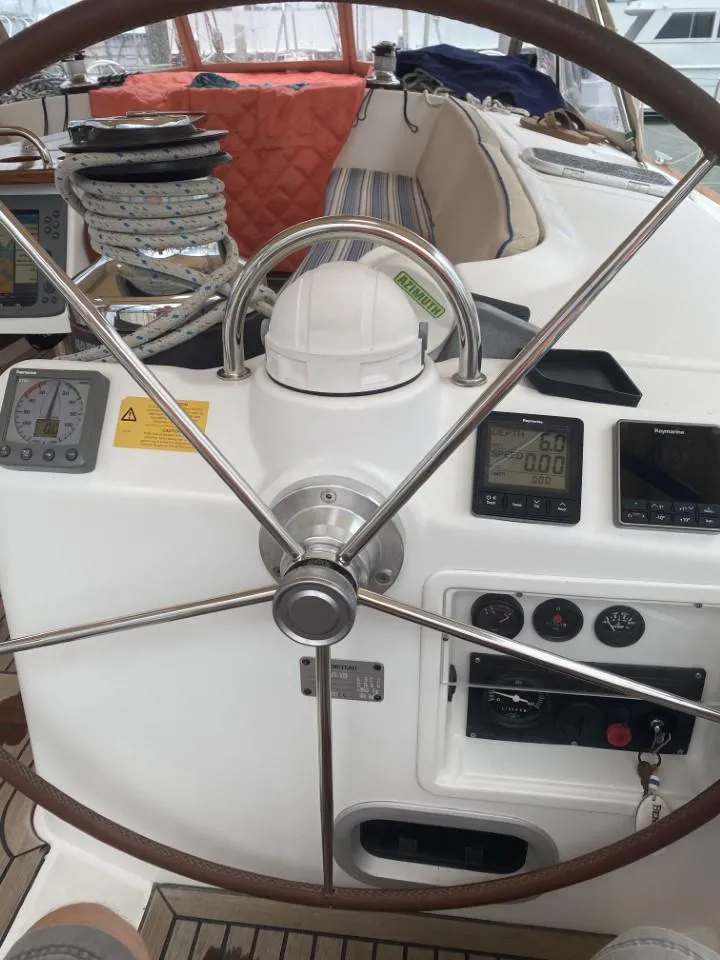Slide: The Image of Steering wheel and controls of a 2006 Beneteau Oceanis 523 sailboat cockpit. - 19