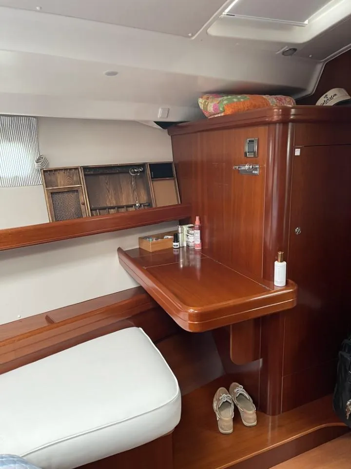 Slide: The Image of Interior of 2006 Beneteau Oceanis 523 yacht with wooden desk and seating area. - 21