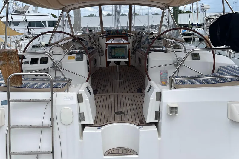 Slide: The Image of 2006 Beneteau Oceanis 523 yacht cockpit with dual steering wheels and navigation equipment. - 5