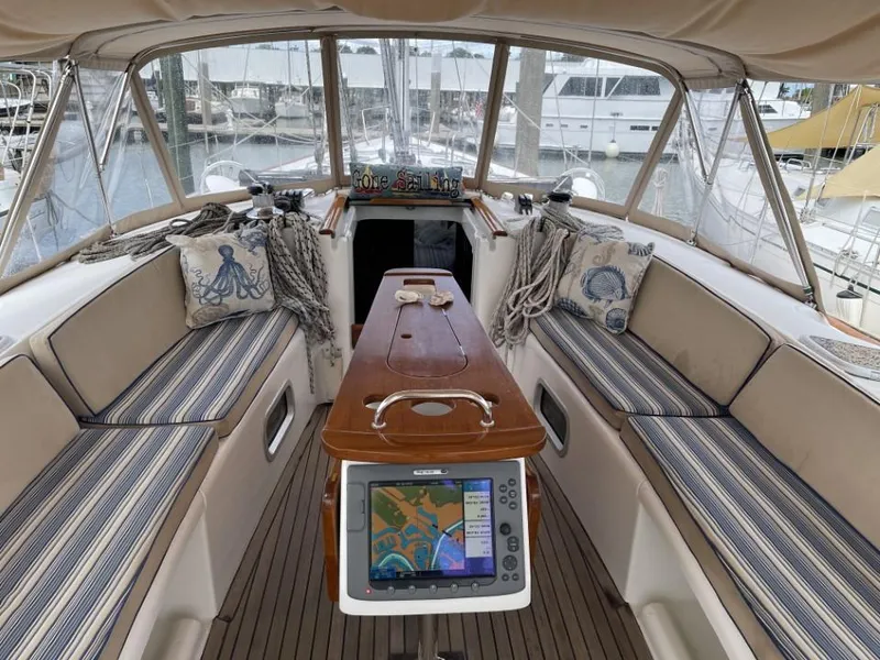 Slide: The Image of Interior of 2006 Beneteau Oceanis 523 sailboat with striped seating and navigation equipment. - 7