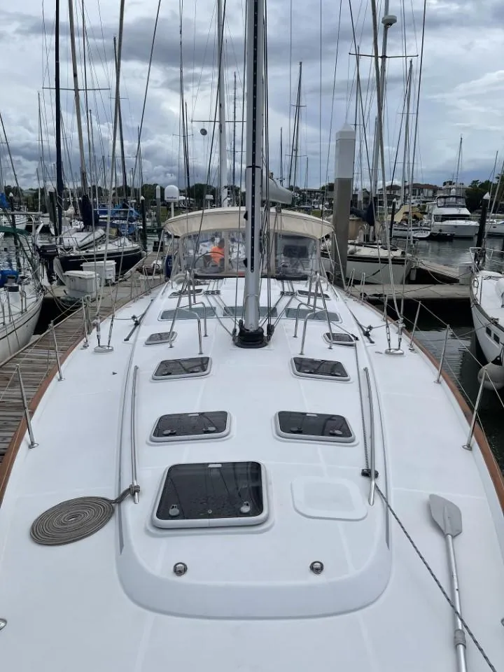 Slide: The Image of 2006 Beneteau Oceanis 523 sailboat docked at marina, overcast sky. - 8
