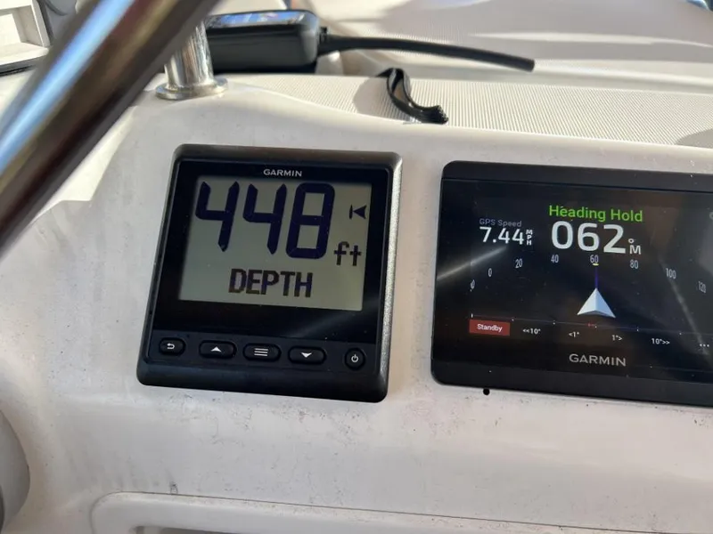 Slide: The Image of Garmin navigation display on 2006 Beneteau Oceanis 523, showing depth and heading. - 9