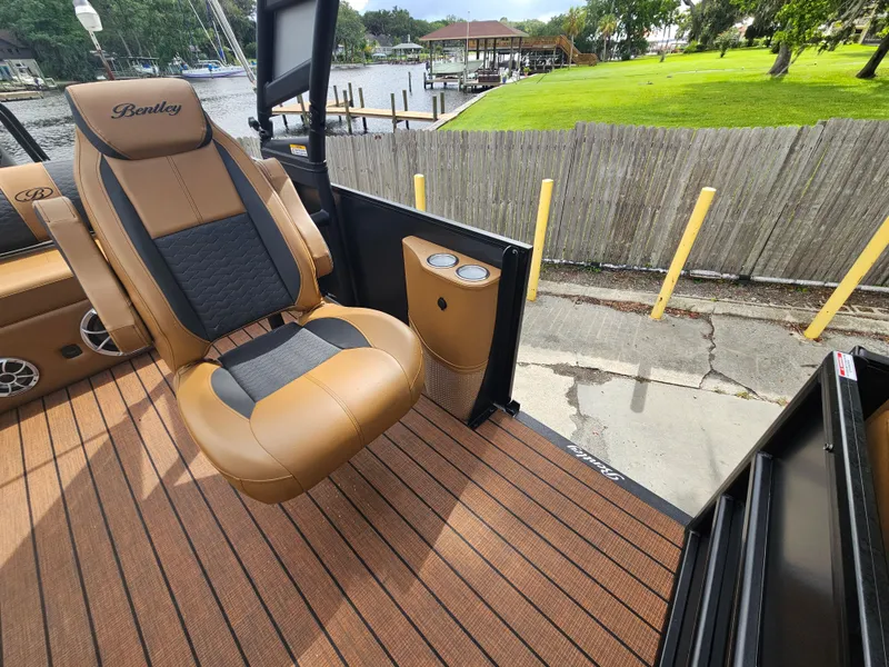 Slide: The Image of 2026 Bentley Pontoons Elite 253 Swingback interior with luxurious seating and waterfront view. - 15