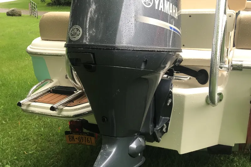 Slide: The Image of Rear view of a 2026 Pioneer 180 Islander boat with Yamaha outboard motor. - 11