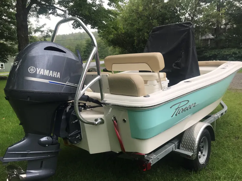 Slide: The Image of 2026 Pioneer 180 Islander boat with Yamaha outboard motor on a trailer, parked on grass. - 3