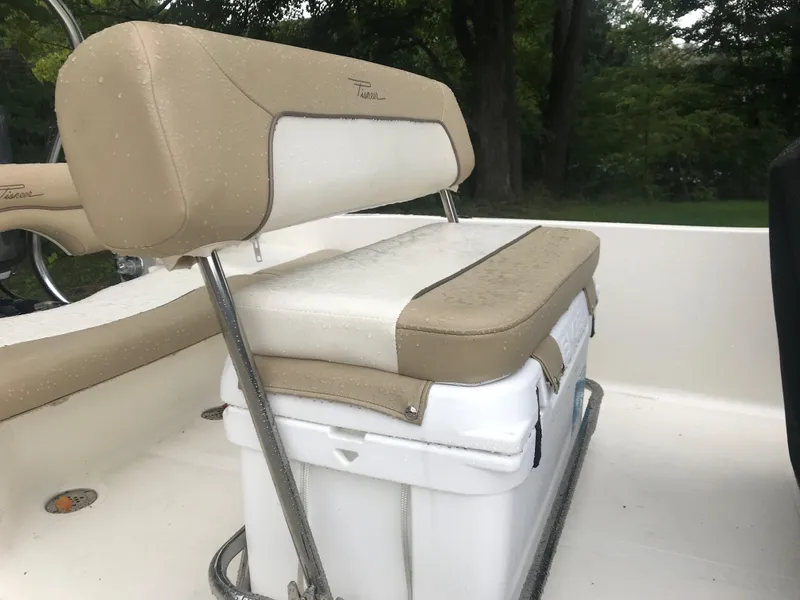 Slide: The Image of 2026 Pioneer 180 Islander boat seat with beige and white upholstery, featuring a cooler underneath. - 6