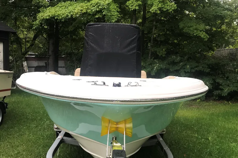 Slide: The Image of 2026 Pioneer 180 Islander boat on trailer, surrounded by lush green trees. - 9