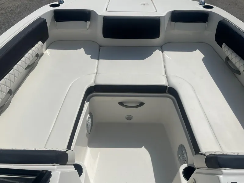 Slide: The Image of Interior seating of 2022 Bayliner DX 2200 boat, featuring white and black upholstery. - 10